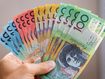 hand holding assortment of Australian cash notes