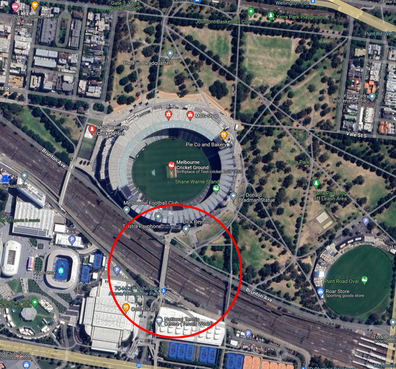 The Melbourne Cricket Ground from above with the train line circled.