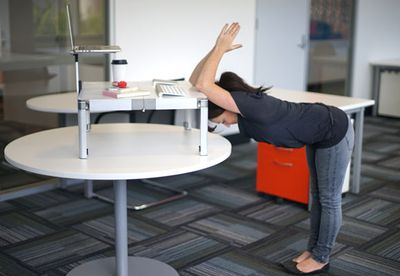 Standing elbow-to-desk stretch