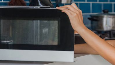 Woman using microwave