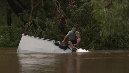 Floodwaters edged closer as he awaited rescue. (9NEWS)