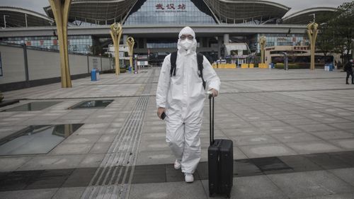 A passengers wear protective clothing arrive in Wuhan Railway Station 