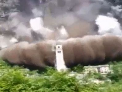 420-year-old church Santuario di Gallivaggio remained standing after being engulfed by the landslide