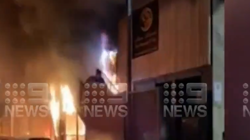 Woman runs down stairwell as building burns in Adelaide