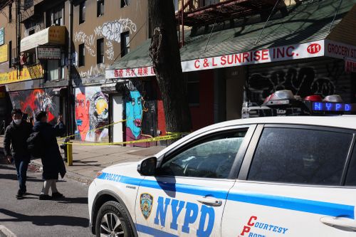 An NYPD vehicle is parked in front of the building where Christina Yuna Lee lived.