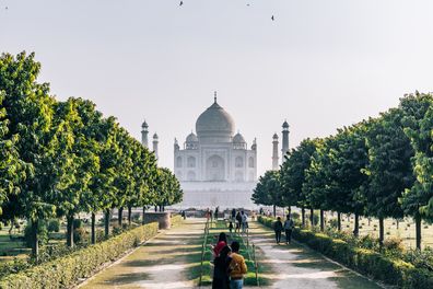 The Taj Mahal seen at sunset from the Mehtab Bagh. It lies north of the Taj Mahal complex on the opposite side of the Yamuna River. The garden complex is perfectly aligned with the Taj Mahal on the opposite bank