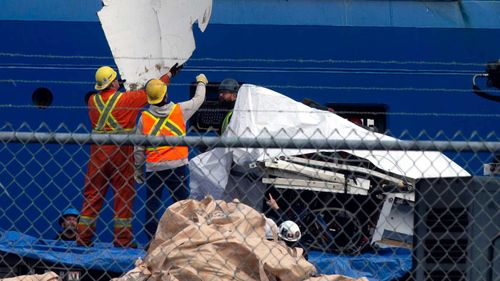 Debris from the Titan submersible, recovered from the ocean floor near the wreck of the Titanic, is unloaded from the ship Horizon Arctic at the Canadian Coast Guard pier in St. John's, Newfoundland.