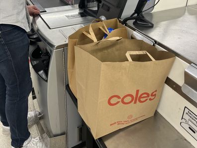 shopping bags at supermarket groceries coles woolworths aldi 