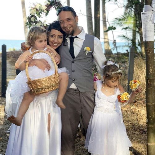Caroline Thomas and her husband Julian Simon, pictured on their wedding day in Australia with their two children.