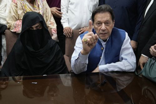 Pakistan's former Prime Minister Imran Khan, right, and Bushra Bibi, his wife, speak to the media before signing documents to submit surety bond over his bails in different cases, at an office of Lahore High Court in Lahore, Pakistan, on July 17, 2023.  