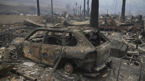 The Palisades Fire ravages a neighborhood amid high winds in the Pacific Palisades neighborhood of Los Angeles, Wednesday, Jan. 8, 2025. (AP Photo/Damian Dovarganes)