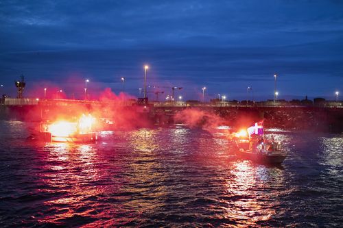 French fishermen light flares as they block the entrance to the port of Saint-Malo, western France, Friday, Nov. 26, 2021. 
