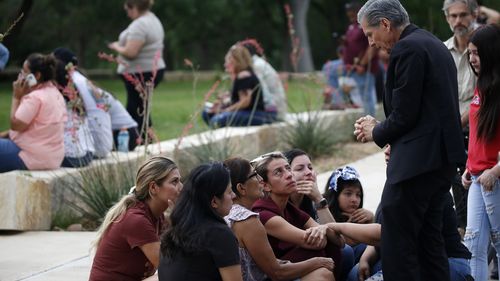The archbishop of San Antonio, Gustavo Garcia-Siller, right, comforts families outside the Civic Center following a deadly school shooting at Robb Elementary School in Uvalde, Texas.