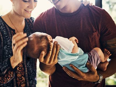 Man and women holding baby