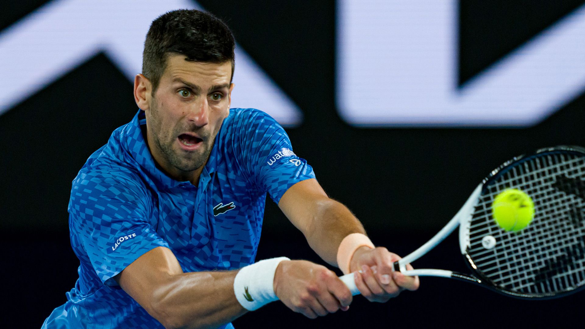 Novak Djokovic of Serbia plays a backhand in the Australian Open men&#x27;s singles final against Stefanos Tsitsipas.