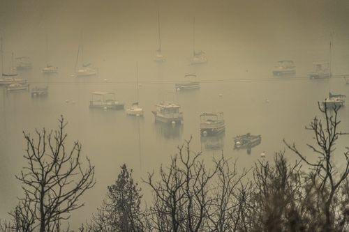 Boats seen through the smoke at Whiskeytown Lake. Picture: AP