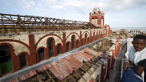 A youth stands near a ruined Cathederal in Jeremie, Haiti. (AP)