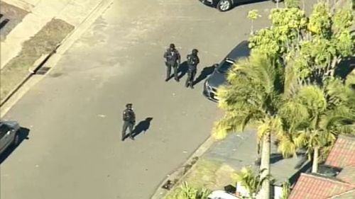 Officers outside the home. (9NEWS)