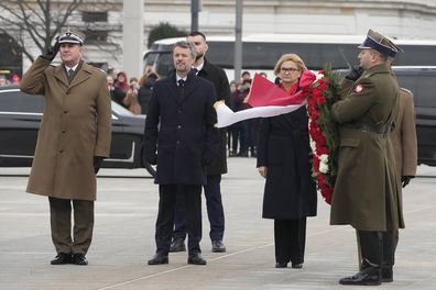 King Frederik X, centre, pays his respects to Polish war dead at the Tomb of the Unknown Soldier in Warsaw, Poland, on Wednesday, Jan. 31, 2024.  