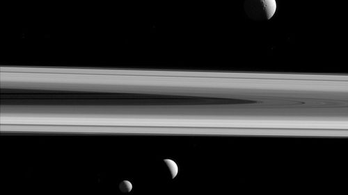 Three of Saturn's moons - Tethys, above, Enceladus, second left, and Mimas, seen from the Cassini spacecraft. (NASA)