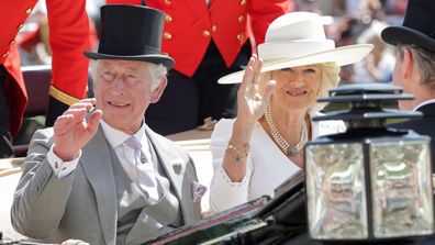 Prince Charles, Prince of Wales and Camilla, Duchess of Cornwall wave as they arrive into the parade ring on the royal carriage during Royal Ascot 2022 at Ascot Racecourse.