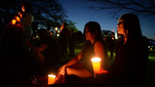Mourners at a vigil for murdered transgender woman Mayang Prasetyo in Brisbane. (AAP)