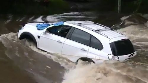 The woman was with her 65-year-old daughter, who was driving, when their car got swept off the causeway in strong floodwaters (Supplied).