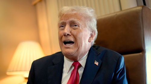 President Donald Trump speaks to reporters aboard Air Force One where he signed a proclamation declaring Feb. 9 Gulf of America Day as he travels from West Palm Beach, Fla. to New Orleans, Sunday, Feb. 9, 2025. (AP Photo/Ben Curtis)
