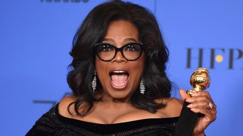 Oprah Winfrey poses in the press room with the Cecil B. DeMille Award at the 75th annual Golden Globe Awards. (AAP)