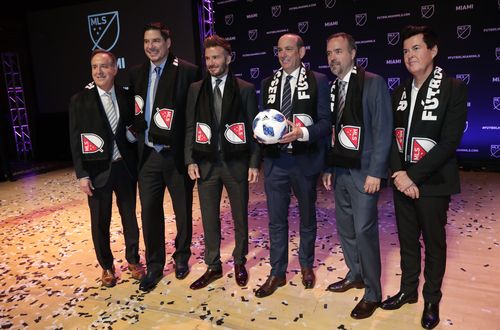 David Beckham, third from left, poses for a group photo at the announcement that Major League Soccer is bringing an expansion to Miami. From left to right are Jorge Mas, Marcelo Claure, Beckham, MLS Commissioner Don Garber, Jose Mas, and Simon Fuller.  (AAP)