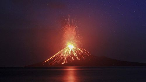 A long exposure photo shows lava erupting from Mount Anak Krakatau volcano, 19 July 2018 (reissued 23 December 2018). 