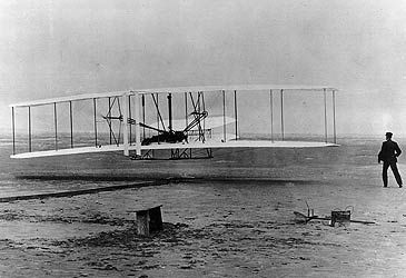 When did the Wright brothers make the first powered and controlled flight?