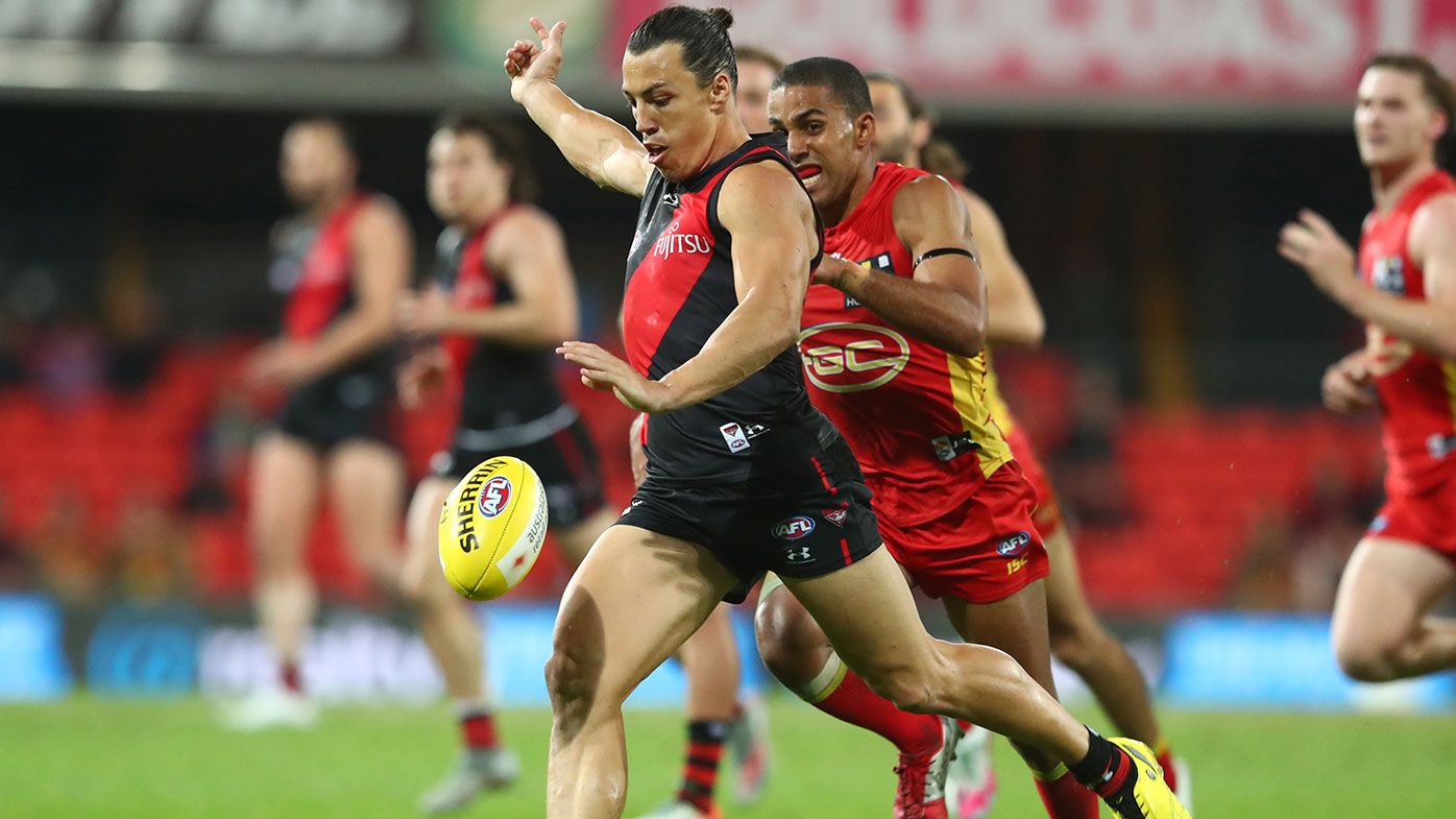 : Dylan Shiel of the Bombers kicks during the round 11 AFL match between the Gold Coast Suns and the Essendon Bombers at Metricon Stadium on August 12, 2020 in Gold Coast, Australia. (Photo by Chris Hyde/Getty Images)