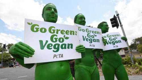 Animal rights activists from PETA wearing little more than body paint, protest in Brisbane outside the G20. (AAP)
