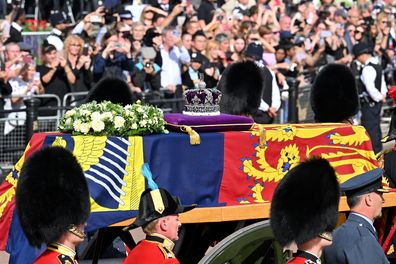 The coffin carrying Queen Elizabeth II makes its way along The Mall during the procession for the Lying-in State of Queen Elizabeth II on September 14, 2022 in London, England. Queen Elizabeth II's coffin is taken in procession on a Gun Carriage of The King's Troop Royal Horse Artillery from Buckingham Palace to Westminster Hall where she will lay in state until the early morning of her funeral. Queen Elizabeth II died at Balmoral Castle in Scotland on September 8