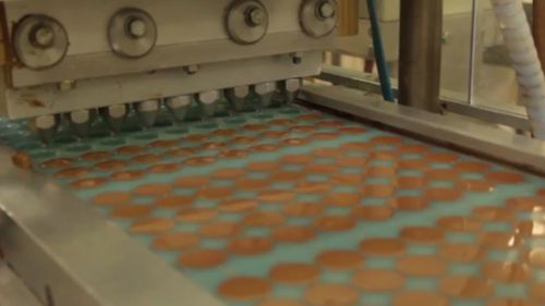 A machine pumps the melted chocolate into egg-shaped moulds. 