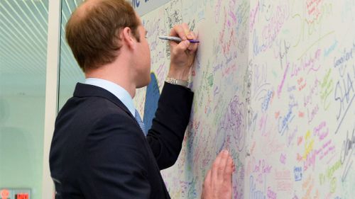 Prince William  writes a message on the anti-bullying board at the Diana Award Inspire Day at Haven Point Leisure Centre in South Shields, north-east England in 2013. (AFP)