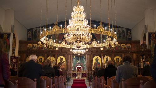 Religious services and gatherings for up to 20 people are now permitted in Victoria. Parishioners are welcomed back at East Keilor Panagia Soumela. (Daniel Pockett)