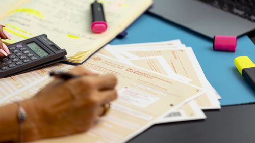 Generic picture of someone filling out a tax return.