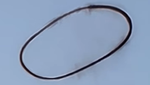 A black ring in the sky has slowly disappeared before shocked witnesses, raising questions about its origin. 