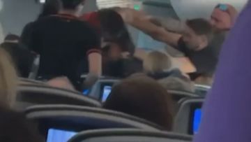 Fight breaks out on flight from Bali to Brisbane.