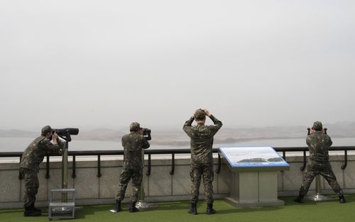 South Korean army soldiers watch the North Korea side from the Unification Observation Post in Paju, South Korea, near the border with North Korea, Friday, March 24, 2023. 