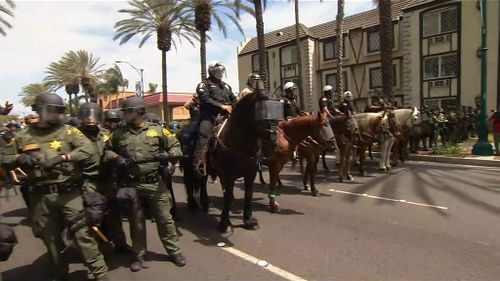 Armed and mounted police were called to the clash. (9NEWS)