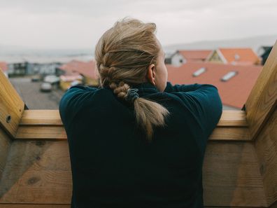 Young woman looking out window