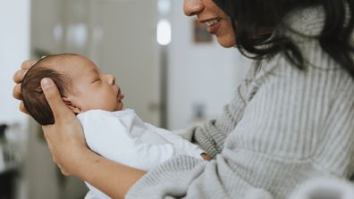 Mother holding her infant baby