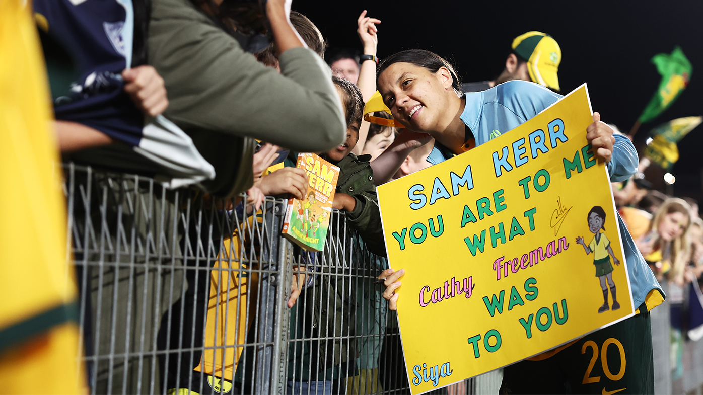 Sam Kerr interacts with a young fan after the Matildas&#x27; international friendly match with Thailand.
