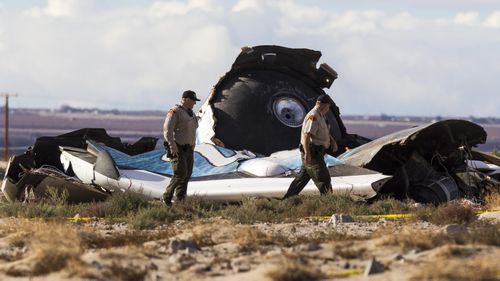 Official survey the wreckage near the site where a Virgin Galactic space tourism rocket exploded and crashed in November 2014. (AAP)