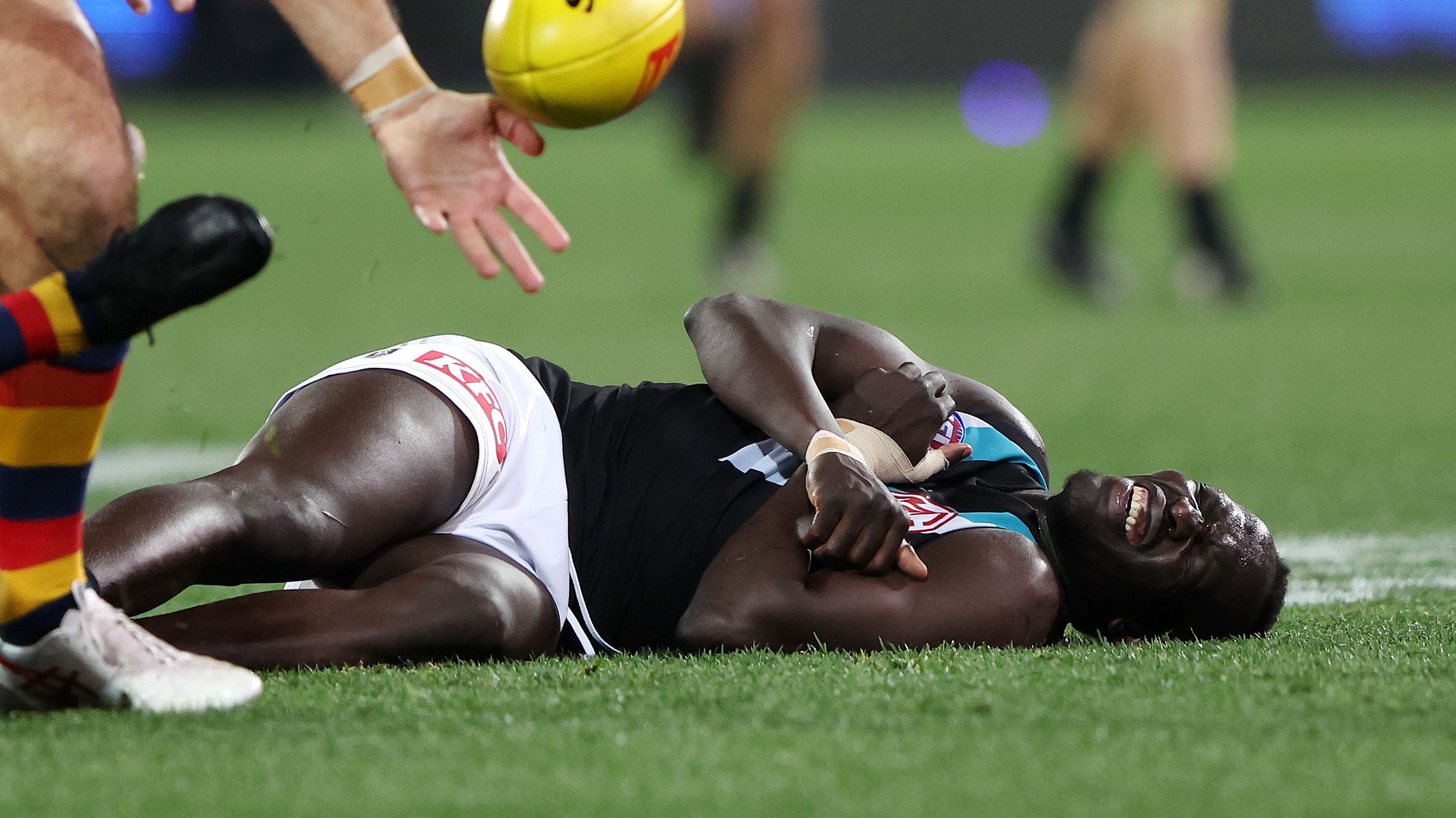 Aliir Aliir of the Power down after a collision with Lachie Jones of the Power during the 2023 AFL Round 20 match between the Adelaide Crows and the Port Adelaide Power at Adelaide Oval on July 29, 2023 in Adelaide, Australia. (Photo by Sarah Reed/AFL Photos via Getty Images)