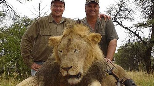 Mr Palmer (left) posing with Cecil's body after the hunt.