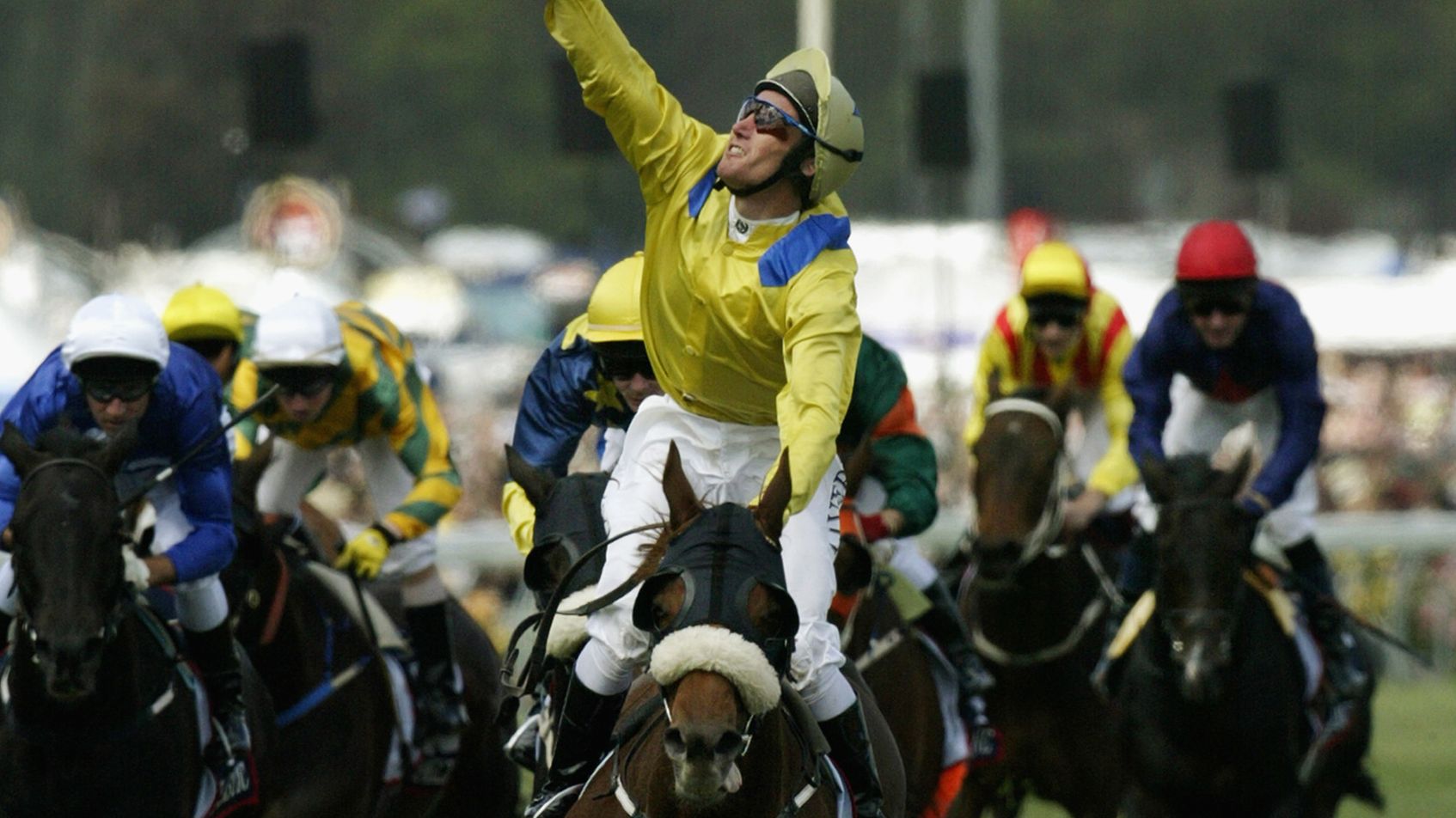MELBOURNE - NOVEMBER 5:  Damien Oliver celebrates on &#x27;Media Puzzle&#x27; after winning the 2002 Tooheys New Melbourne Cup at Flemington Racecourse in Melbourne, Australia on November 5, 2002. (Photo by Adam Pretty/Getty Images)